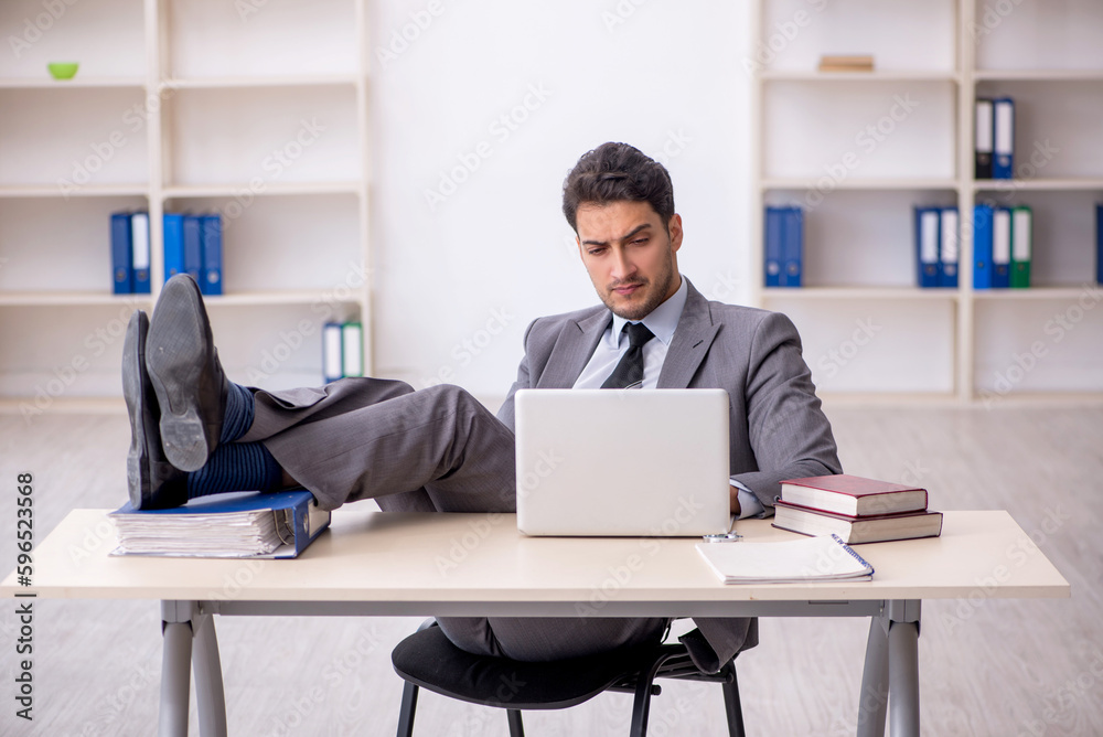 Young male employee working in the office Young male employee working in the office