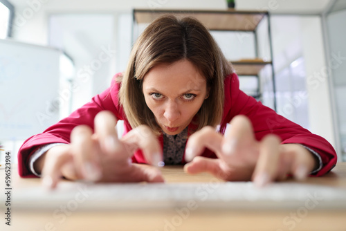 Aggressive employee stretches out hands typing on keyboard