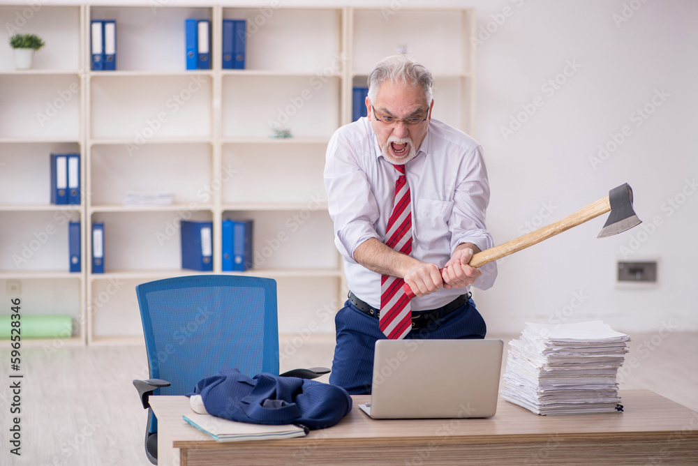 Old male employee unhappy with excessive work in the office Old male employee unhappy with excessive work in the office