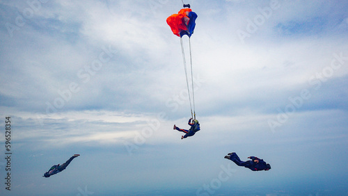 Student Skydiver deploys parachute with two instructors photo