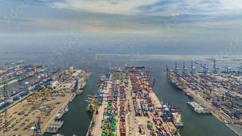 Aerial view of sea cargo port with containers and cranes. Tanjung Priok port. Indonesia.