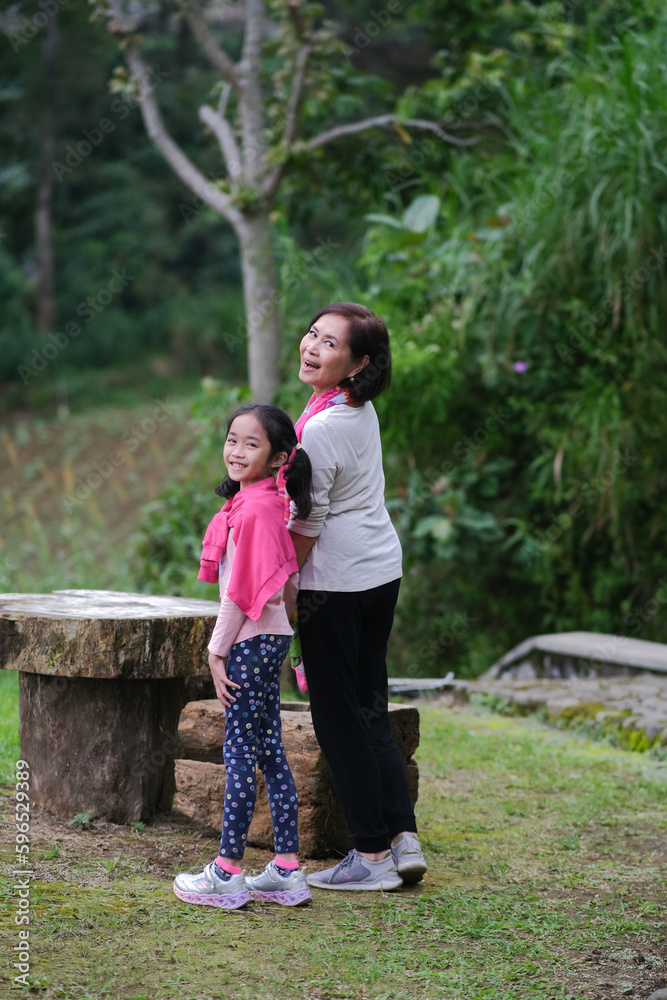 Fototapeta premium A girl and a middle-aged woman turning around and smiling.