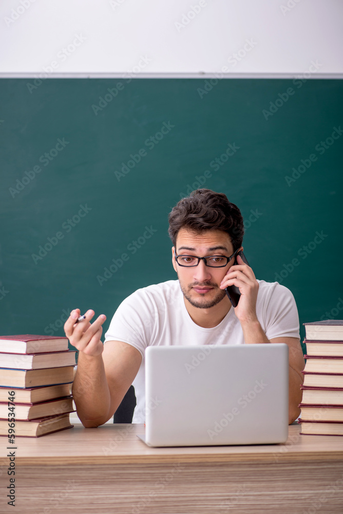 Young male student sitting in the classroom