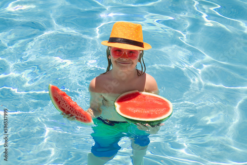 Happy child in swimming pool. Summer kids vacation. Summer watermelon fruit for children.