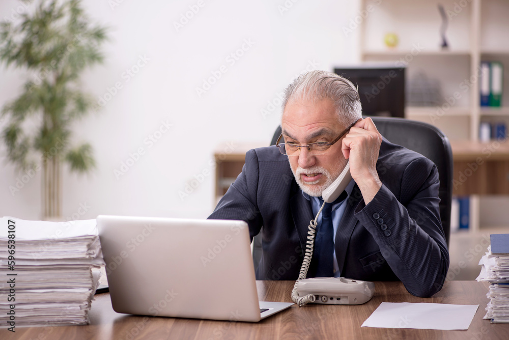 Old male employee and too much work in the office Old male employee and too much work in the office