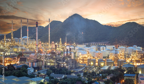 Oil refinery, aerial petrochemical storage tanks with refining industrial floor, oil refinery at night. photo