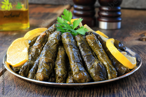 Delicious yaprak dolma (sarma) stuffed grape leaves rice. Lebanese dolma sarma on plate. Lebanon turkish greek middle eastern cuisine. (Turkish name; Yaprak sarma) photo