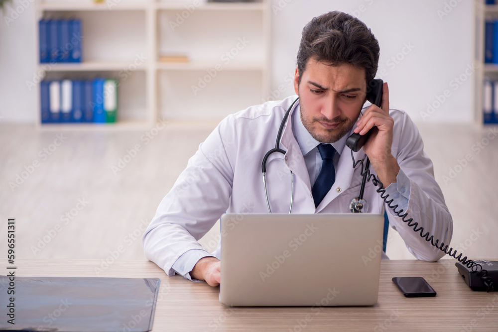 Young male doctor in telemedicine concept Young male doctor in telemedicine concept