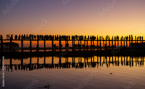 Amarapura  Myanmar - November 22  2016  Unidentified people walk on U Bein bridge at sunset in Myanmar. U Bein bridge is the longest teak bridge in the world.