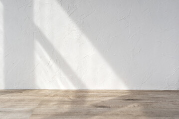 Empty room design template, white plaster texture wall and beige wooden floor surface with sunlight shadow, home interior, product stand mockup background for business brand advertisement, copy space