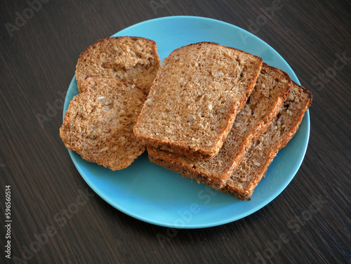 whole grain bread in plate on wooden background, Organic Homemade Whole Wheat Bread, closeup