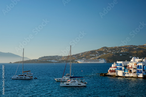Sunset in Mykonos, Greece, with cruise ship and yachts in the harbor