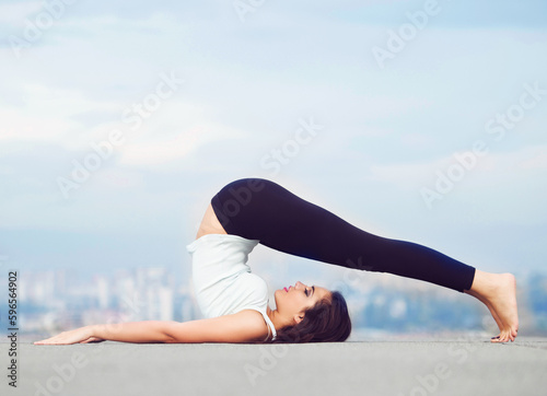 Fitness, yoga and stretch, woman on roof in city, stretching legs and back in wellness or body balance mockup. Health care, pilates and mindfulness, workout for girl and cityscape view on rooftop.