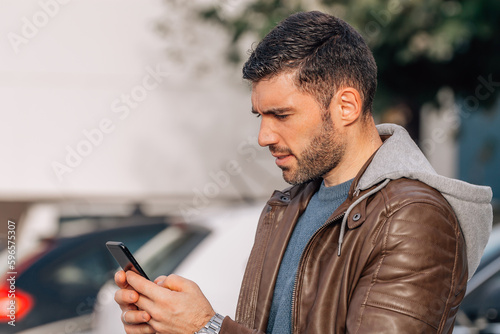 urban young man with phone on the street