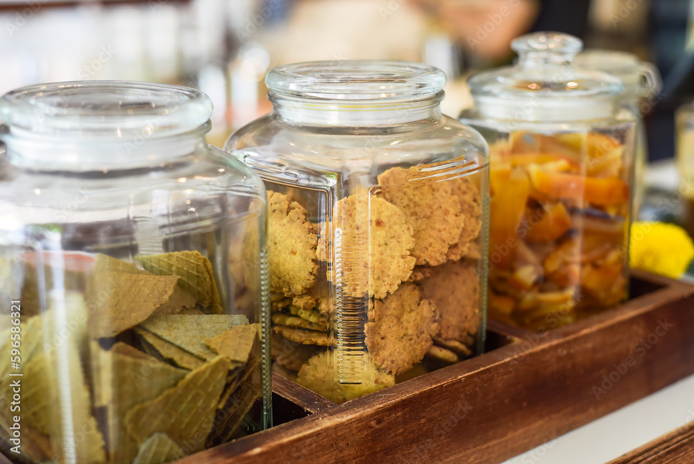Jar full of circle homemade cookies, cones and dried fruits with copy space Jar full of circle homemade cookies, cones and dried fruits with copy space
