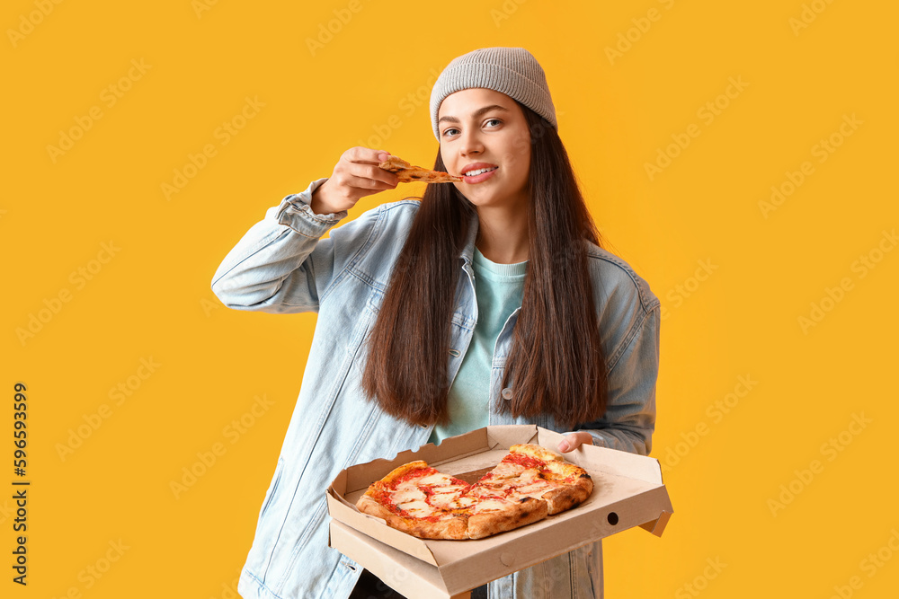 Young woman with tasty pizza on yellow background Young woman with tasty pizza on yellow background
