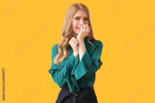 Happy young woman biting na...
