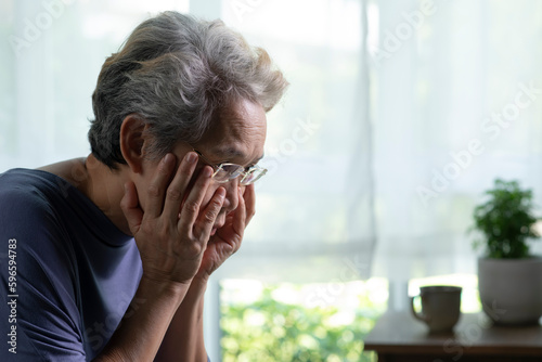 Photography Portrait of sad and lonely Asian senior woman in living room