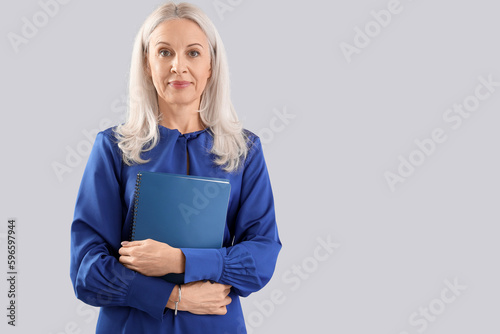 Mature woman with notebook ...
