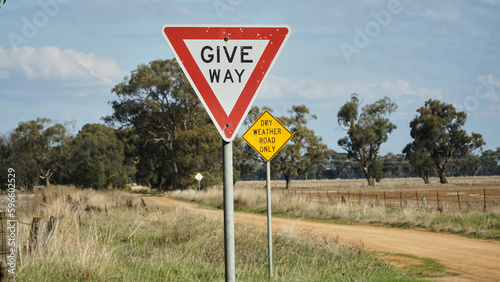 A Give-way and Dry Weather Road Only sign in Rural Victoria Australia. photo