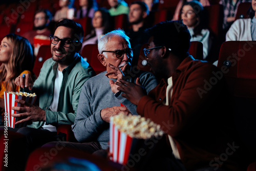 Bilde på lerret Man gesturing be quiet in movie theater.
