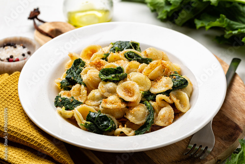 Close-up of Italian pasta Orecchiette con le cime di rapa e le acciughe, Southern Italy dish, typical for Apulia. Made with anchovy, bread crumbs and rapini,  broccoli rabe or turnip greens.
