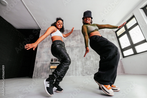 Stylish girls dancing in studio.