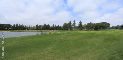 golf course with forest and pond