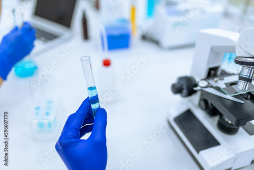 Scientist examining liquid in test tube in laboratory