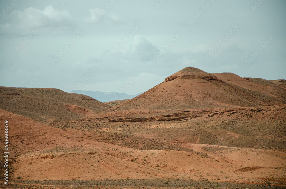 Desert landscapes in Morocco, desolate lands with paths that lead to remote and unexplored corners. Climate change and arid climate. Desertification and lack of water. Mountains and hills 