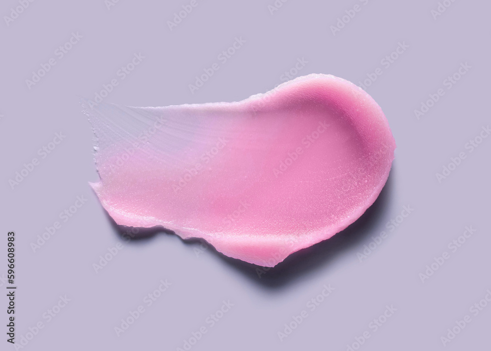 Cosmetic pink lip balm or face cleansing balm butter swatch isolated on gray Cosmetic pink lip balm or face cleansing balm butter swatch isolated on gray