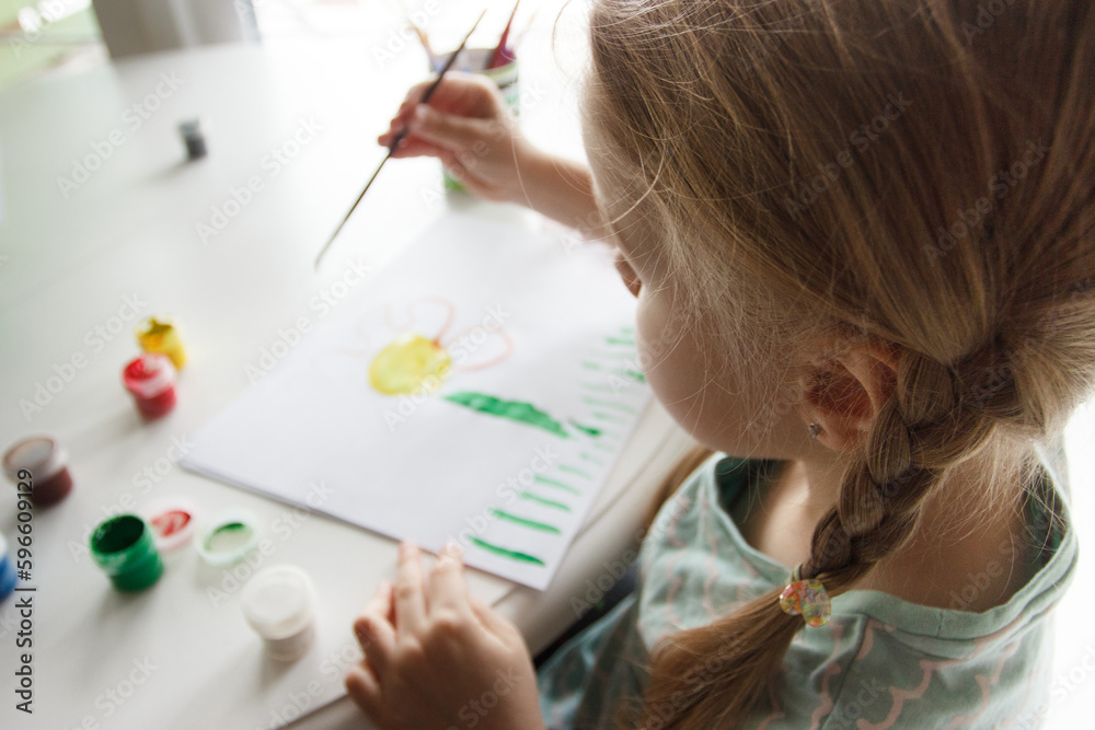 Little child draws with watercolor, concept of education in the kindergarten Little child draws with watercolor, concept of education in the kindergarten