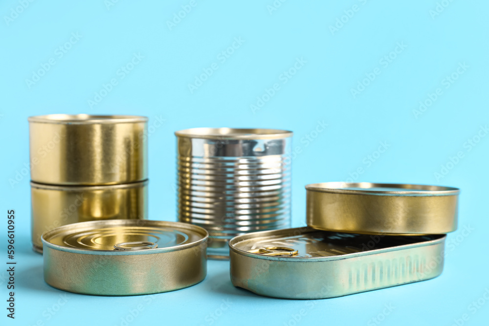 Tin cans with fish on blue background Tin cans with fish on blue background
