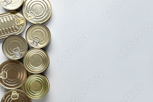 Assortment of tin cans with fish on white background