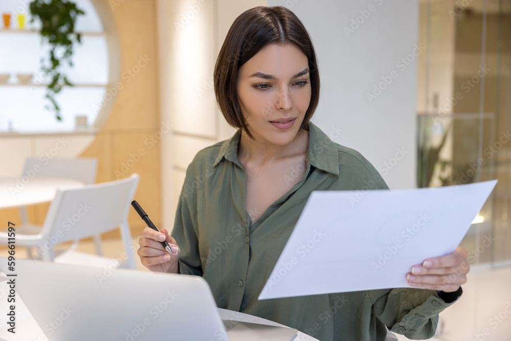 Focused young female secretary dealing with paperwork Focused young female secretary dealing with paperwork