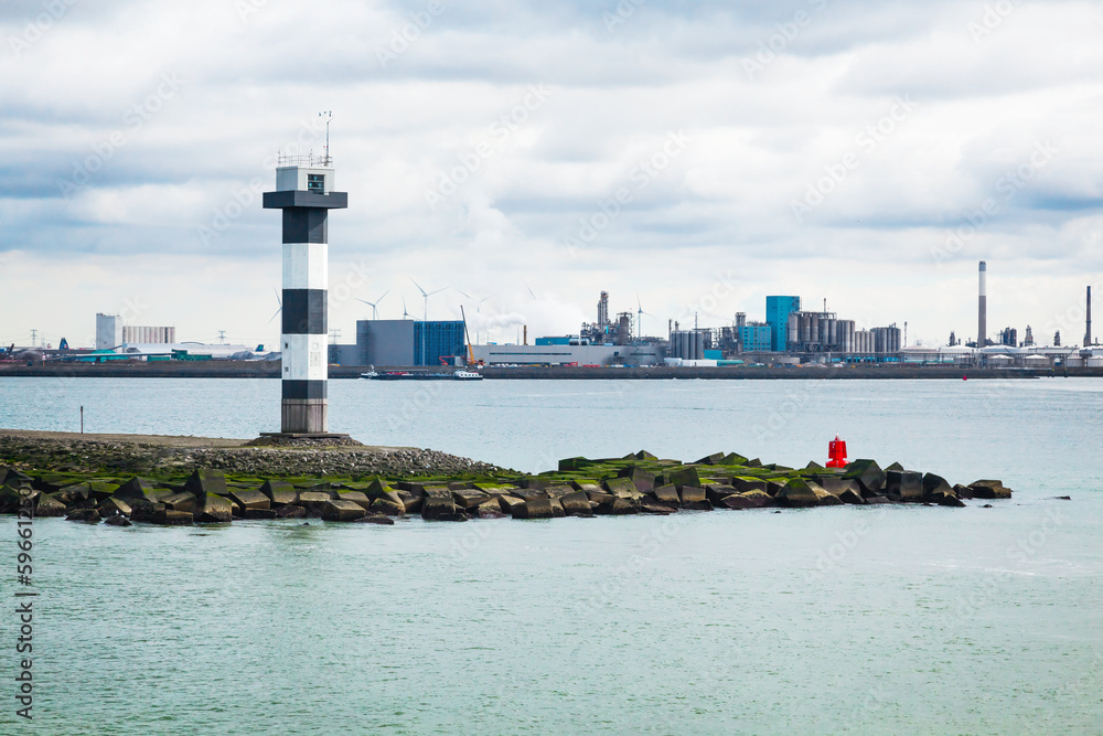 A river lighthouse in the middle of a water channel near the port of Rotterdam.