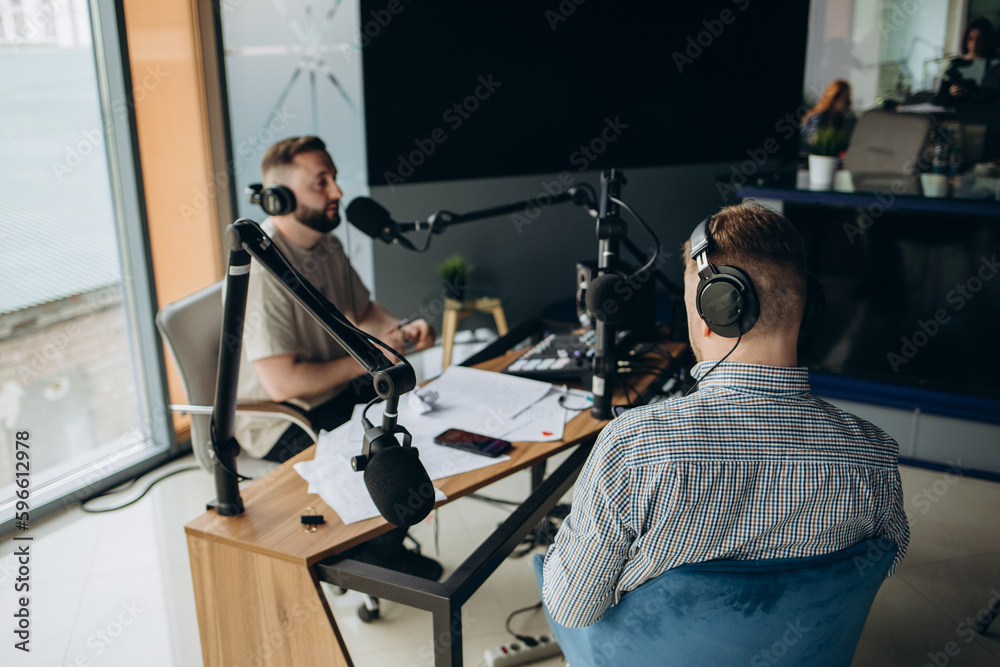 Two radio hosts moderating a live show for radio Two radio hosts moderating a live show for radio