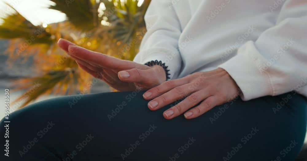 Female hands tapping rhythm tempo on the knees outdoors, close-up