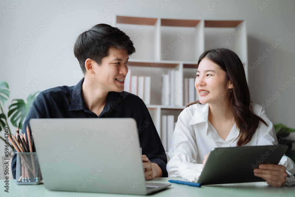 cute cheerful young couple using laptop and analyzing their finances with documents. cute cheerful young couple using laptop and analyzing their finances with documents.