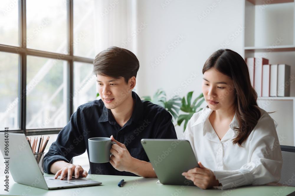 Asian couple sitting at table at home, using laptop to check documents overdue bills, taxes, debt due, bank account balance.lack of money bankruptcy, financial problems concept. Asian couple sitting at table at home, using laptop to check documents overdue bills, taxes, debt due, bank account balance.lack of money bankruptcy, financial problems concept.