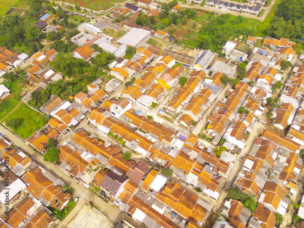 Aerial photography. Aerial drone view of one residential at Bandung city - Indonesia, with green fields and many houses