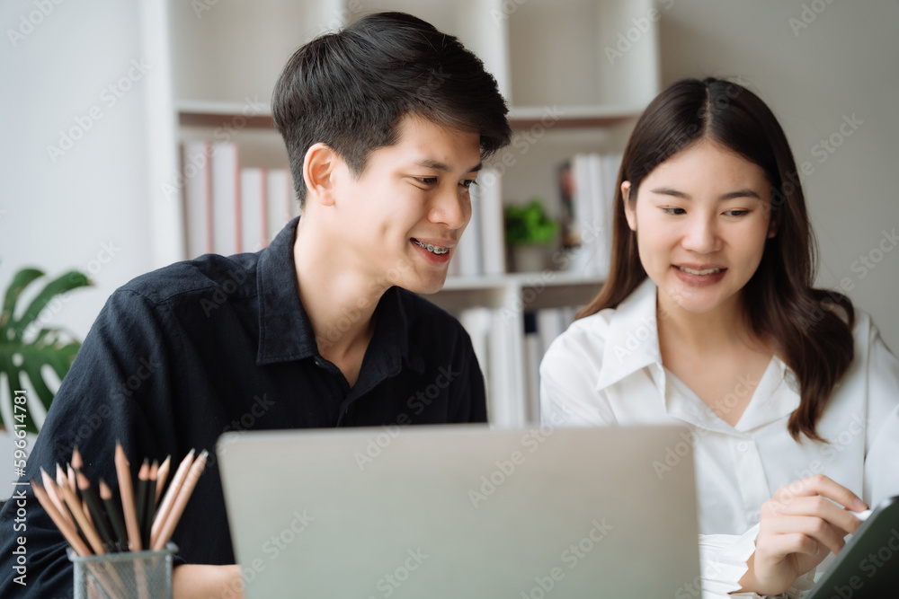cute cheerful young couple using laptop and analyzing their finances with documents. cute cheerful young couple using laptop and analyzing their finances with documents.