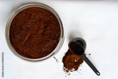A glass jar with coffee on a white background