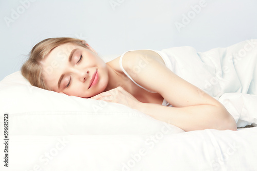 Young beautiful girl sleeps in the bedroom.