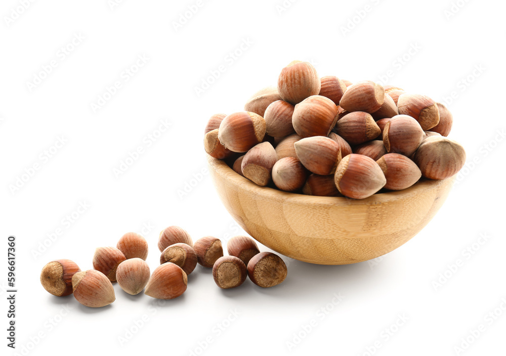 Bowl with shelled hazelnuts on white background Bowl with shelled hazelnuts on white background