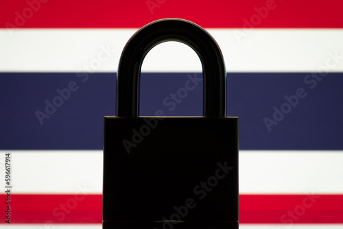 Flag of Thailand with silhouette of closed lock on the foreground. Closed country Thailand, sanctions, embargo concept