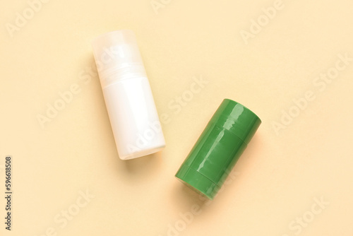 Two deodorant bottles on yellow background