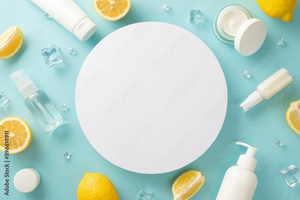 Citrus summer beauty concept. Top view flat lay of skincare products with lemon on pastel blue background with empty circle for text or advert