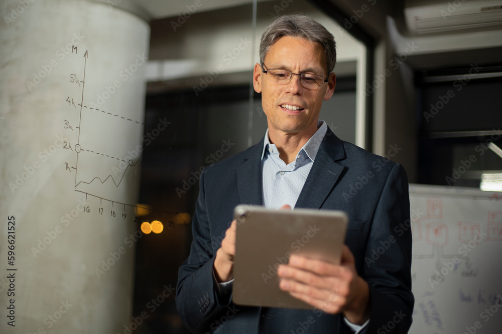 Portrait of businessman in office. Man using digital tablet. Businessman having video call.. Portrait of businessman in office. Man using digital tablet. Businessman having video call..