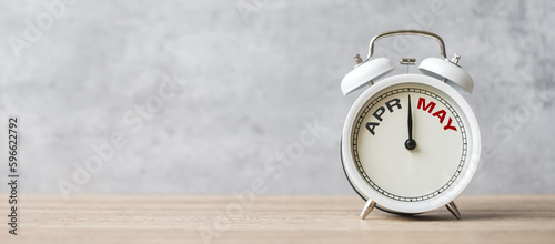 Hello May Changed from April month with vintage alarm clock on table background. Calendar, Monthly, New Start, Resolution, Goals, Plan, Action and Mission Concept